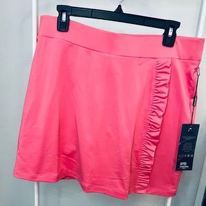 Head brand golf skort. Size L. Salmon colored.